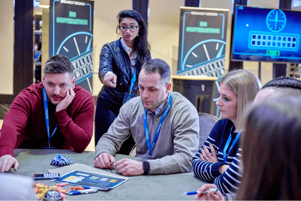 A group of men and women sat around a table participating in an activity at Keyline's corporate event