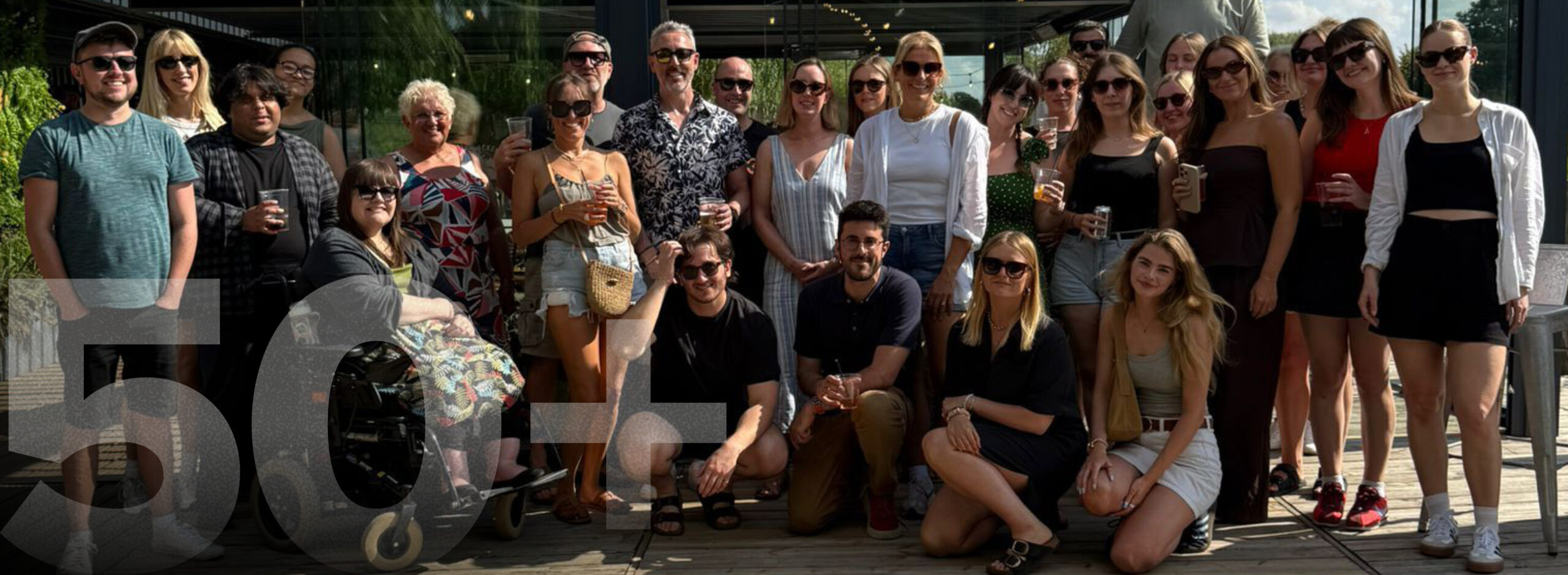 OA396 - our people colour 50 staff members dressed in summer clothes smile at the camera