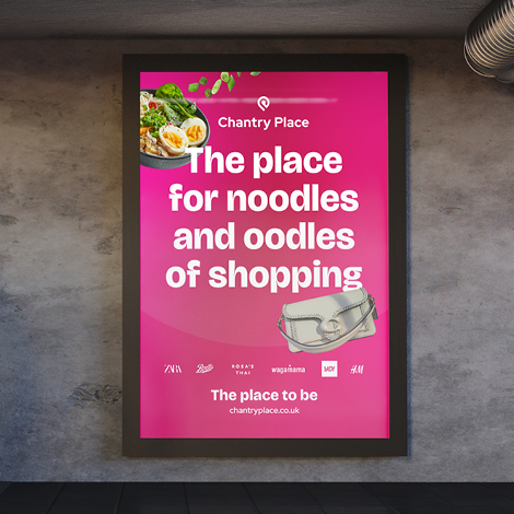 A bright pink poster with pictures of a handbag and a bowl of noodles. The text reads 'the place for noodles and oodles of shopping'